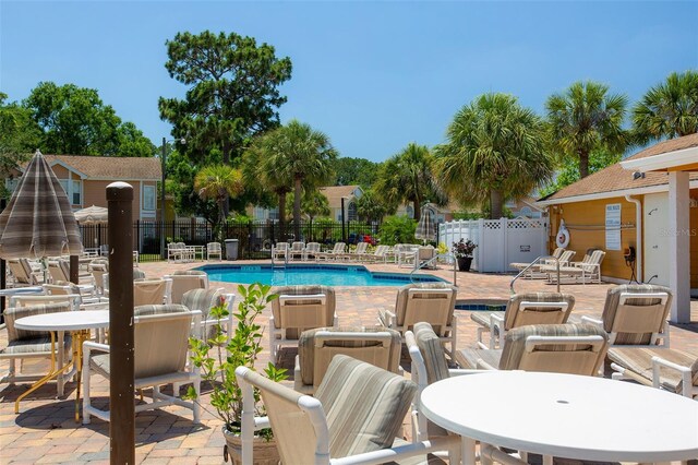 2438 Sweetwater Club Cir Unit 50, Kissimmee, FL 34746 - community pool with fence and a patio area