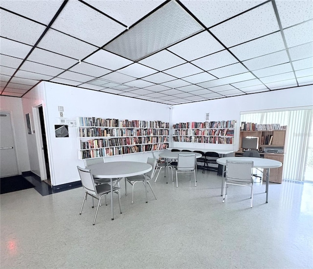 870 Virginia St Unit 108, Dunedin, FL 34698 - dining room with a paneled ceiling, speckle patterned floor, and baseboards