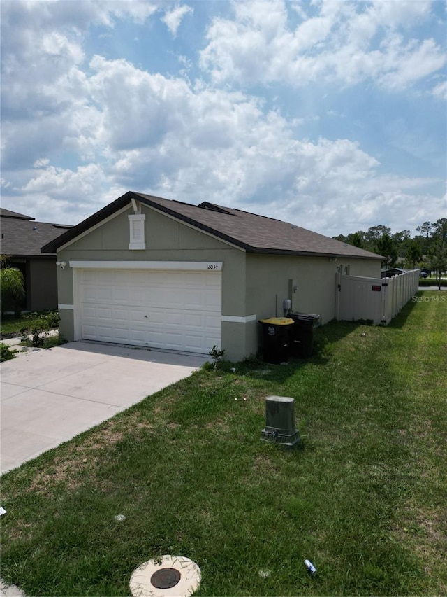 2034 Old Pasture Ln, Lakeland, FL 33801 - view of property exterior featuring driveway, an attached garage, and stucco siding