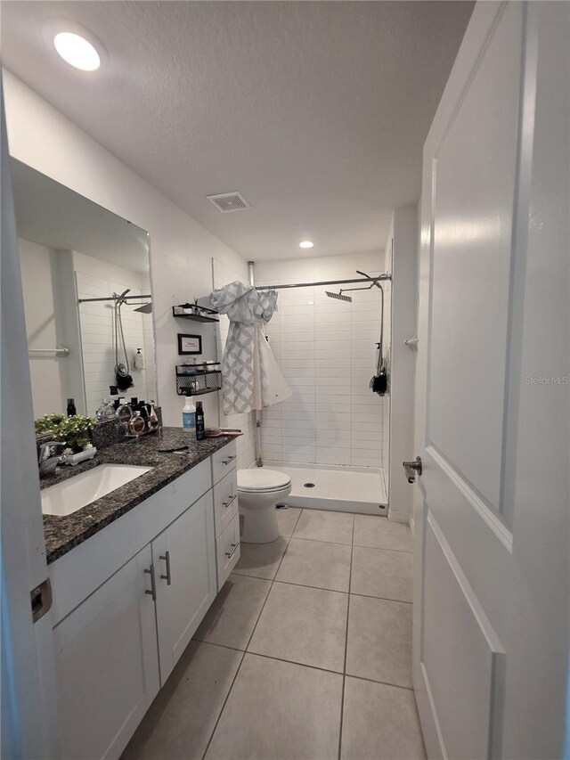 2034 Old Pasture Ln, Lakeland, FL 33801 - full bath featuring a stall shower, toilet, vanity, and tile patterned flooring