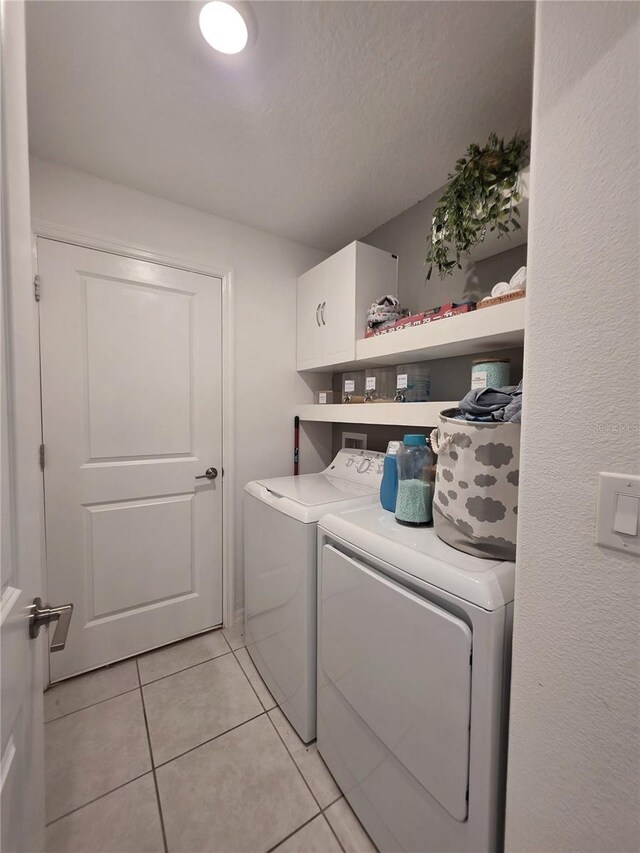 2034 Old Pasture Ln, Lakeland, FL 33801 - laundry room featuring cabinet space, separate washer and dryer, and light tile patterned floors