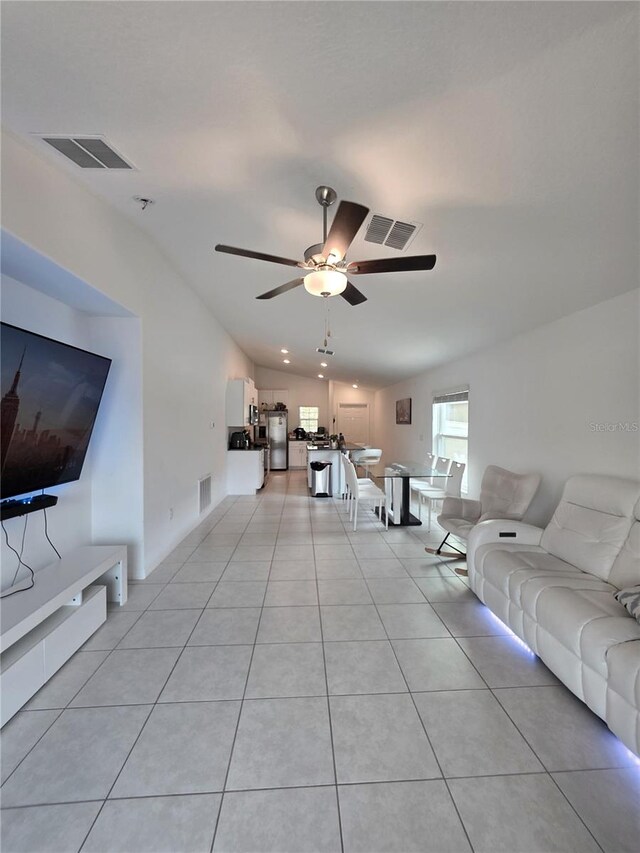 2034 Old Pasture Ln, Lakeland, FL 33801 - living room with ceiling fan, light tile patterned flooring, and lofted ceiling
