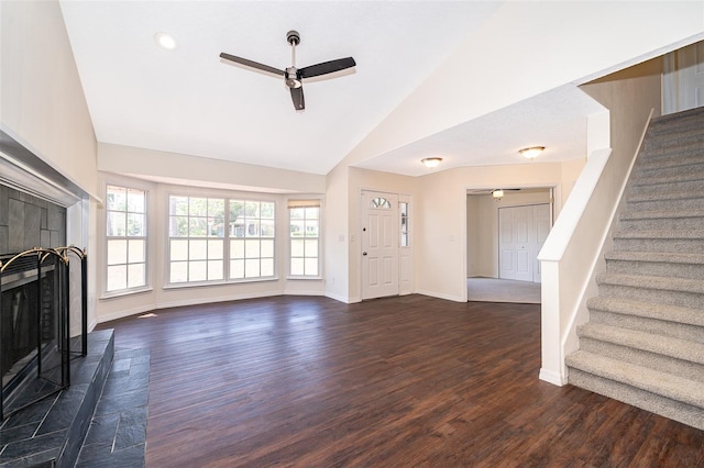 120 W Minnehaha Ave, Clermont, FL 34711 - unfurnished living room featuring a ceiling fan, a tiled fireplace, stairs, dark wood-style flooring, and baseboards