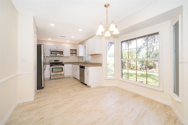 120 W Minnehaha Ave, Clermont, FL 34711 - kitchen featuring appliances with stainless steel finishes, a sink, baseboards, a chandelier, and recessed lighting