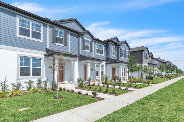 12190 Plumpton Dr, Winter Garden, FL 34787 - view of property with a residential view, a front yard, and stucco siding