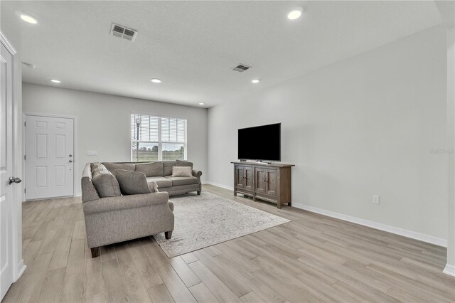 12190 Plumpton Dr, Winter Garden, FL 34787 - living room featuring light wood-type flooring, recessed lighting, and baseboards