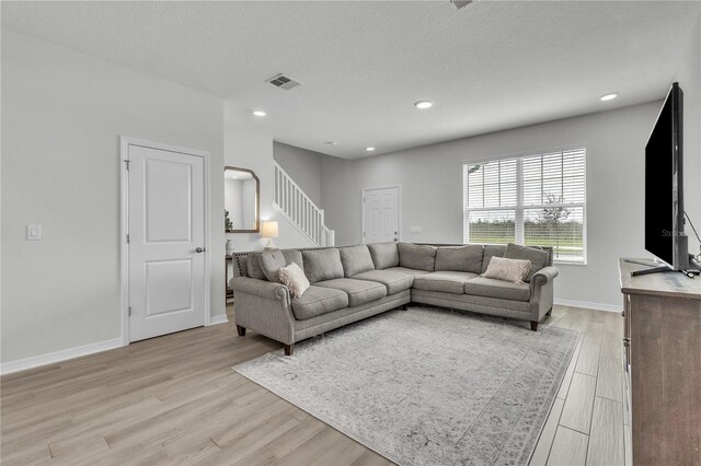 12190 Plumpton Dr, Winter Garden, FL 34787 - living room featuring stairs, light wood-type flooring, baseboards, and recessed lighting
