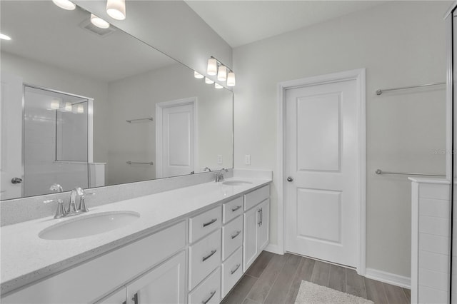 12190 Plumpton Dr, Winter Garden, FL 34787 - bathroom with wood finished floors, double vanity, and baseboards