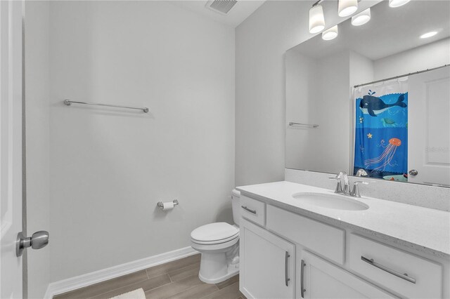 12190 Plumpton Dr, Winter Garden, FL 34787 - bathroom with toilet, baseboards, wood finished floors, vanity, and a shower with curtain
