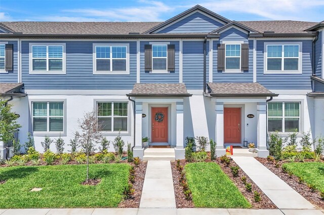 12190 Plumpton Dr, Winter Garden, FL 34787 - townhome / multi-family property with roof with shingles and stucco siding