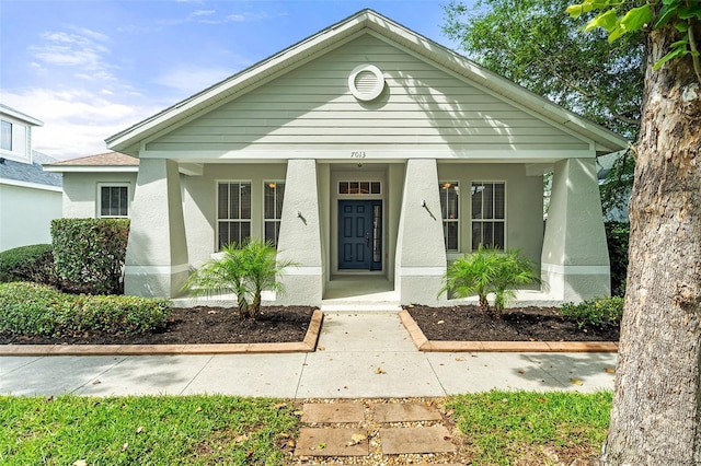 7013 Beargrass Rd, Harmony, FL 34773 - view of front of home featuring covered porch and stucco siding