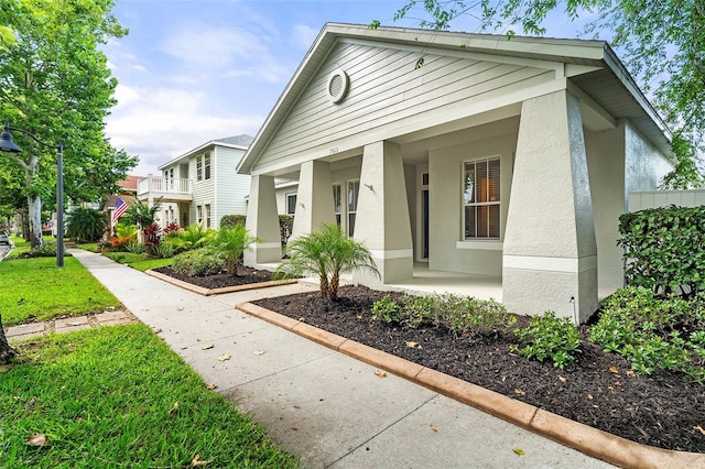 7013 Beargrass Rd, Harmony, FL 34773 - view of front facade featuring stucco siding and a porch