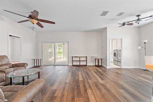 7013 Beargrass Rd, Harmony, FL 34773 - living area featuring washer and clothes dryer, wood finished floors, ceiling fan, and a textured ceiling