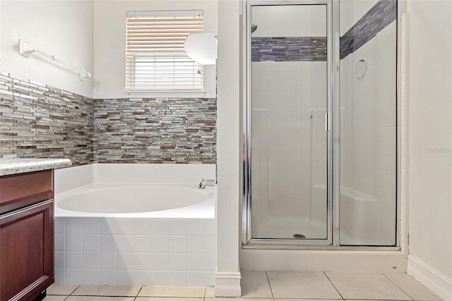 7013 Beargrass Rd, Harmony, FL 34773 - bathroom featuring a stall shower, a bath, tile patterned flooring, and vanity