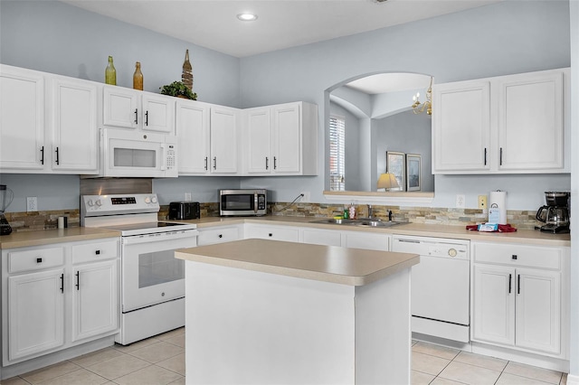 321 Rosso Dr, Davenport, FL 33837 - kitchen with white appliances, a sink, light tile patterned floors, a kitchen island, and recessed lighting