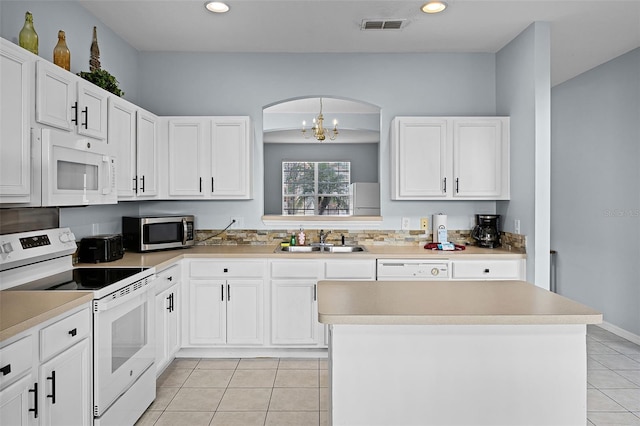 321 Rosso Dr, Davenport, FL 33837 - kitchen with white appliances, a sink, light tile patterned floors, white cabinets, and recessed lighting