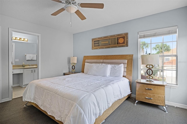 321 Rosso Dr, Davenport, FL 33837 - carpeted bedroom with baseboards, ceiling fan, and ensuite bathroom