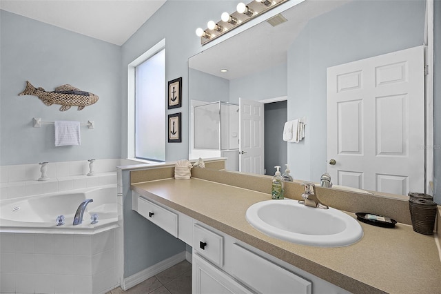 321 Rosso Dr, Davenport, FL 33837 - full bathroom featuring tile patterned floors, a stall shower, vanity, a garden tub, and plenty of natural light