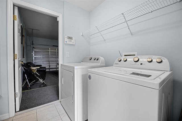 321 Rosso Dr, Davenport, FL 33837 - laundry room with independent washer and dryer and light tile patterned floors