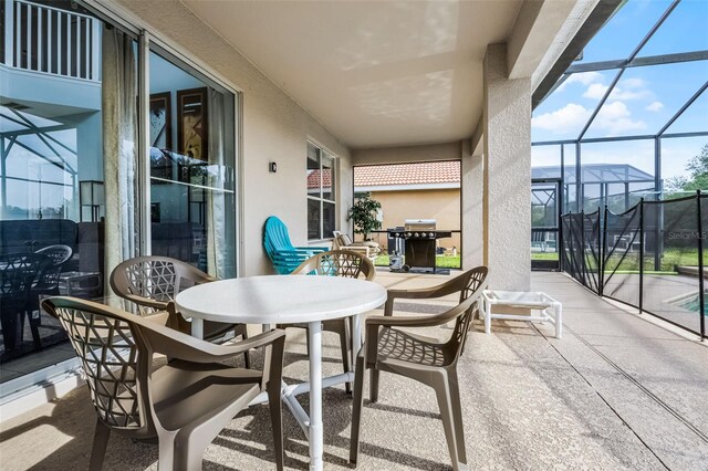 321 Rosso Dr, Davenport, FL 33837 - view of patio with area for grilling, outdoor dining area, and a lanai