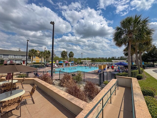 2620 Lodi Cir Unit 103, Kissimmee, FL 34746 - community pool featuring a patio area