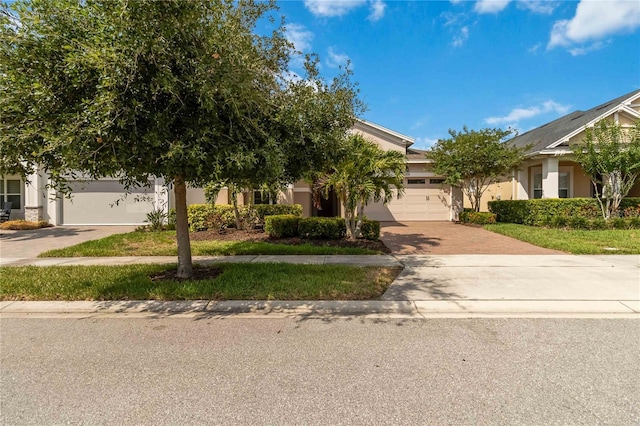 5009 E Fountainwood Dr, Saint Cloud, FL 34772 - obstructed view of property featuring decorative driveway, an attached garage, and stucco siding