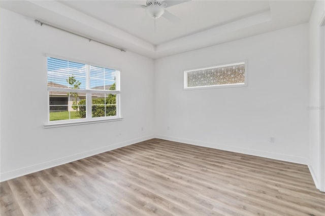5009 E Fountainwood Dr, Saint Cloud, FL 34772 - spare room with light wood-style flooring, a raised ceiling, baseboards, and ceiling fan