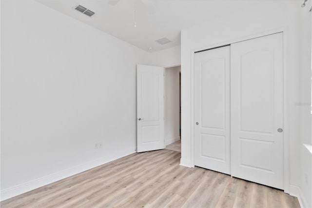 5009 E Fountainwood Dr, Saint Cloud, FL 34772 - unfurnished bedroom with light wood-style floors, a closet, baseboards, and ceiling fan