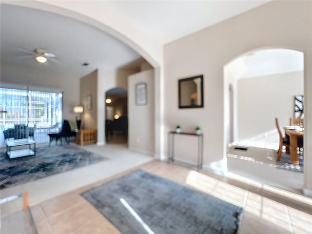 518 Brighton Dr, Davenport, FL 33897 - tiled living room featuring arched walkways and a ceiling fan