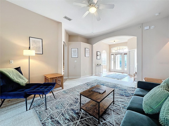 518 Brighton Dr, Davenport, FL 33897 - carpeted living area featuring arched walkways, ceiling fan, and baseboards