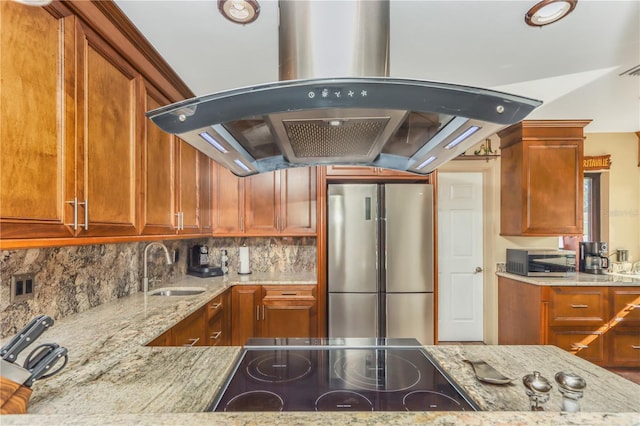 955 Mansfield Rd, Tavares, FL 32778 - kitchen featuring stainless steel appliances, island range hood, light stone counters, a sink, and tasteful backsplash