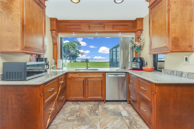 955 Mansfield Rd, Tavares, FL 32778 - kitchen featuring stainless steel appliances, a sink, light stone counters, and stone finish floors