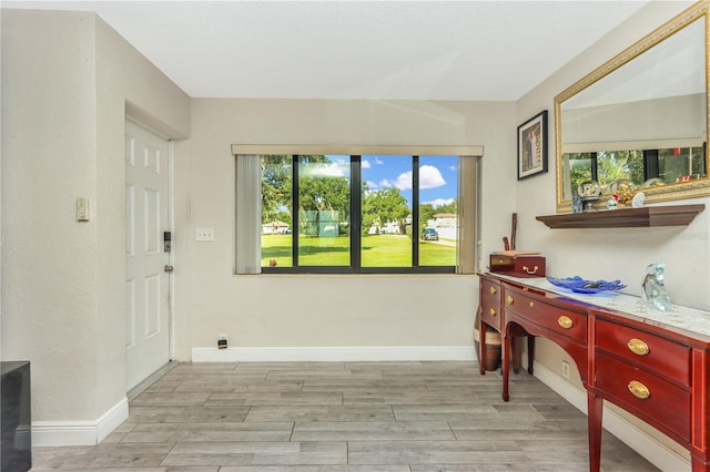 955 Mansfield Rd, Tavares, FL 32778 - foyer entrance featuring light wood finished floors and baseboards