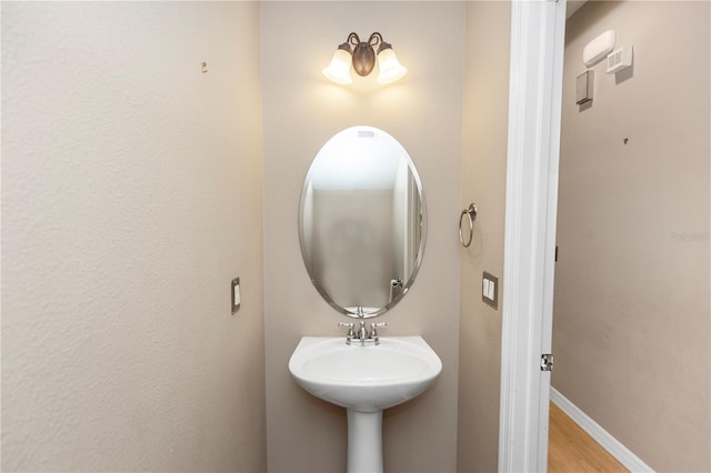 6957 Northwich Dr, Windermere, FL 34786 - bathroom featuring wood finished floors and baseboards