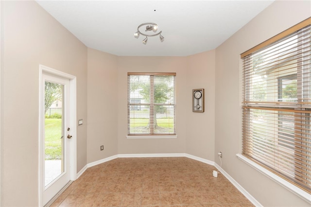 6957 Northwich Dr, Windermere, FL 34786 - empty room featuring light tile patterned flooring and baseboards