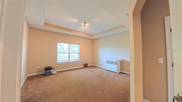 6957 Northwich Dr, Windermere, FL 34786 - carpeted spare room with baseboards, a raised ceiling, and arched walkways