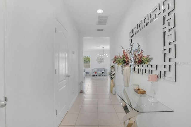 3400 Mt Vernon Way, Kissimmee, FL 34741 - corridor featuring light tile patterned floors, a chandelier, and baseboards