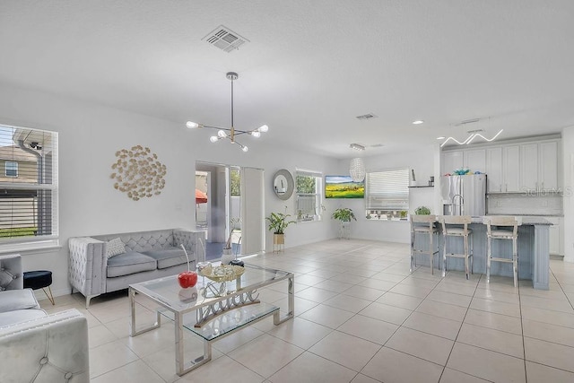 3400 Mt Vernon Way, Kissimmee, FL 34741 - living room featuring light tile patterned floors and a chandelier