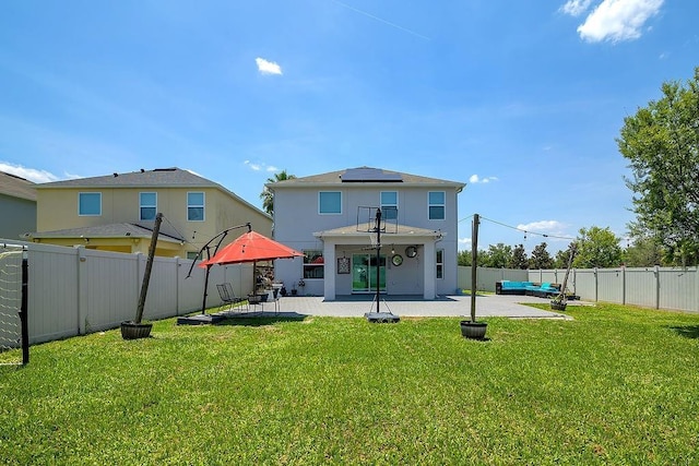 3400 Mt Vernon Way, Kissimmee, FL 34741 - back of house with a patio, roof mounted solar panels, and an outdoor hangout area