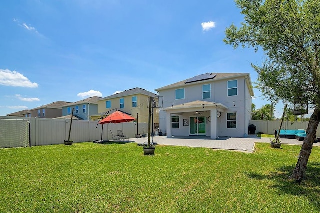 3400 Mt Vernon Way, Kissimmee, FL 34741 - back of house featuring solar panels, a patio area, and stucco siding