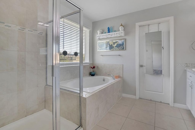 3400 Mt Vernon Way, Kissimmee, FL 34741 - bathroom featuring a stall shower, tile patterned flooring, a bath, vanity, and baseboards