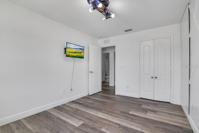 3400 Mt Vernon Way, Kissimmee, FL 34741 - unfurnished bedroom featuring wood finished floors, baseboards, and a closet
