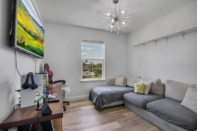 3400 Mt Vernon Way, Kissimmee, FL 34741 - living area with a chandelier, wood finished floors, baseboards, and a textured ceiling