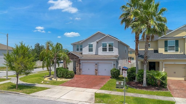 3400 Mt Vernon Way, Kissimmee, FL 34741 - view of front facade featuring decorative driveway, stucco siding, and a garage