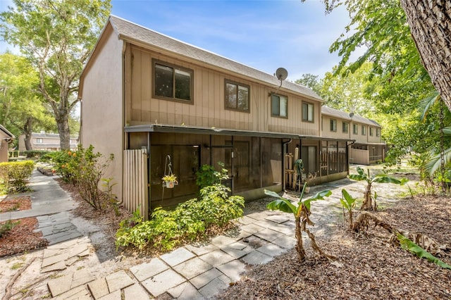 411 Sheoah Blvd Unit 33, Winter Springs, FL 32708 - rear view of property with a sunroom and a shingled roof