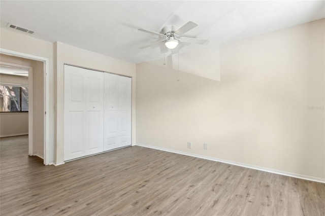 411 Sheoah Blvd Unit 33, Winter Springs, FL 32708 - unfurnished bedroom featuring light wood-style floors, baseboards, a closet, and a ceiling fan