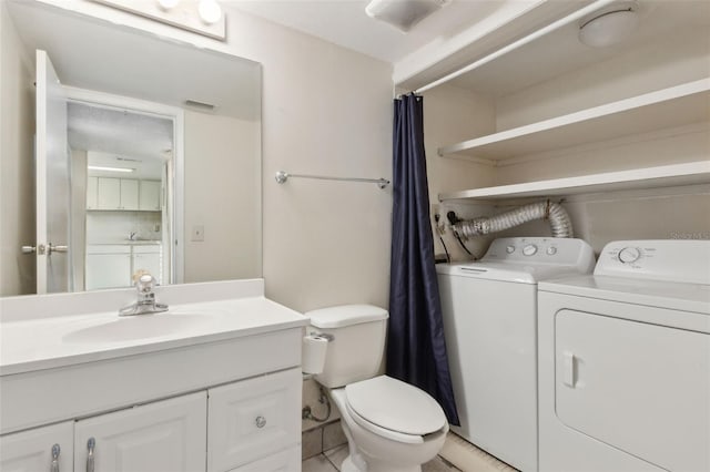 411 Sheoah Blvd Unit 33, Winter Springs, FL 32708 - full bath with separate washer and dryer, toilet, vanity, and tile patterned flooring