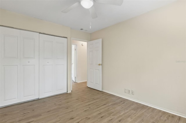 411 Sheoah Blvd Unit 33, Winter Springs, FL 32708 - unfurnished bedroom featuring light wood-type flooring, a closet, baseboards, and ceiling fan