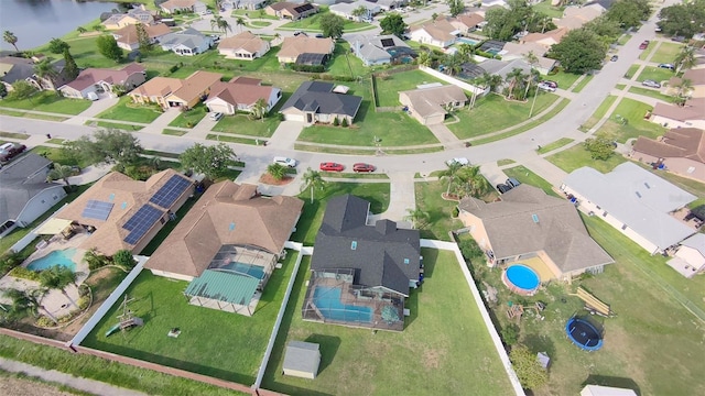 2410 Sweetwater Blvd, Saint Cloud, FL 34772 - aerial overview of property's location with nearby suburban area, a pool, and a nearby body of water