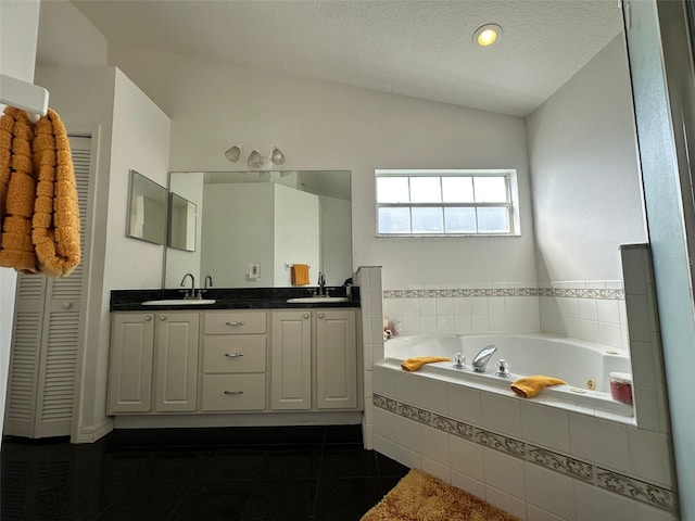 2410 Sweetwater Blvd, Saint Cloud, FL 34772 - bathroom featuring double vanity, a whirlpool tub, tile patterned floors, a textured ceiling, and vaulted ceiling